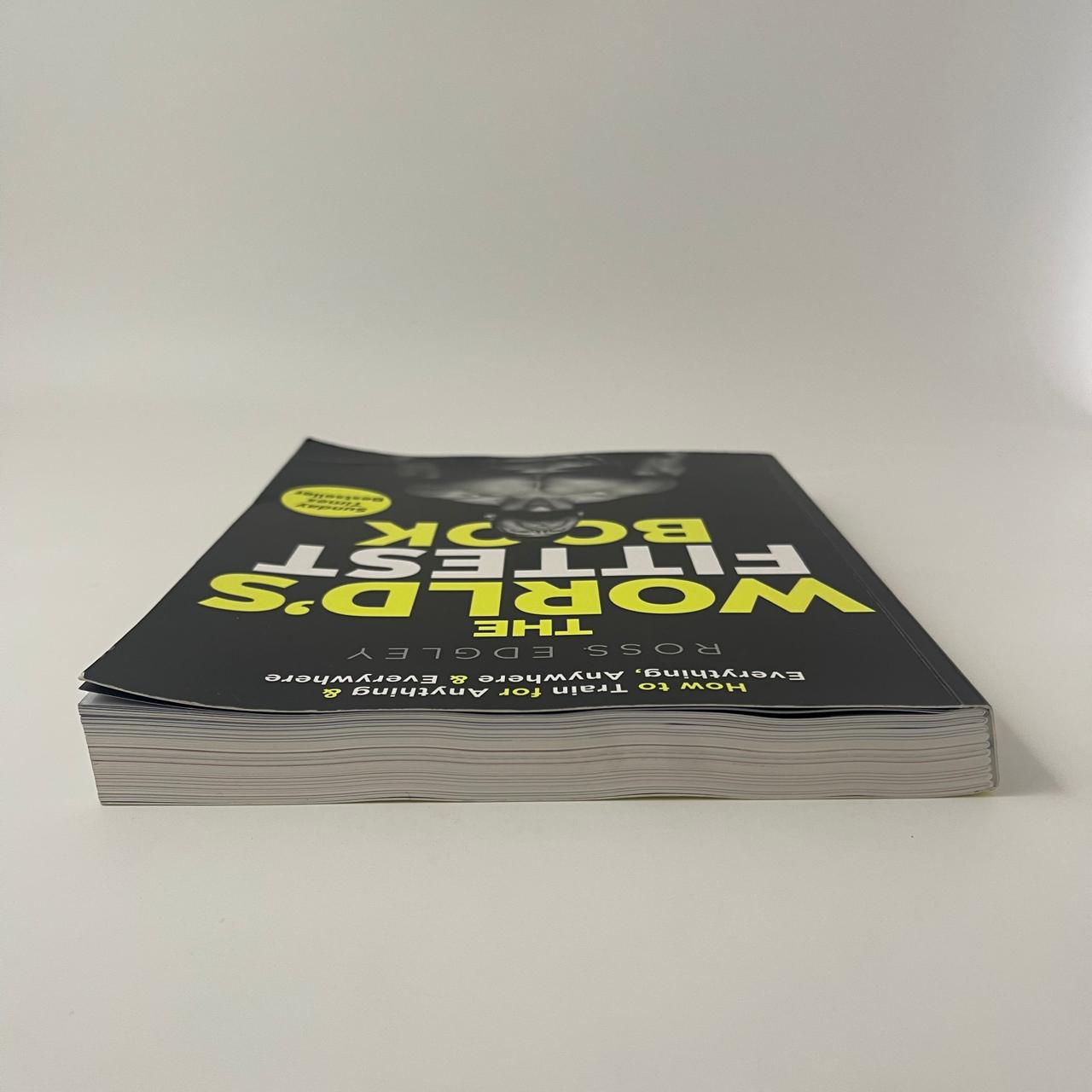 Stack of books titled 'The World's Fittest Back' on a white background