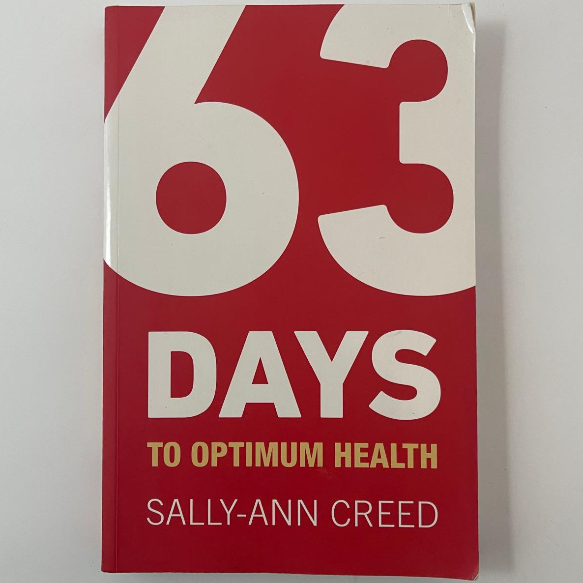 Book titled '60 Days to Optimum Health' by Sally-Ann Creed on a white background